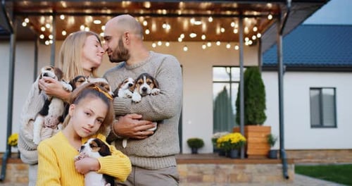 Family Poses with Adorable Beagle Puppies at Home