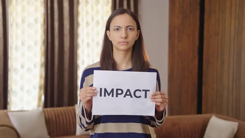 Woman Holding Impact Sign in Living Room