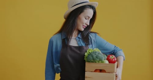 Woman Farmer Holds Organic Vegetables and Chalkboard