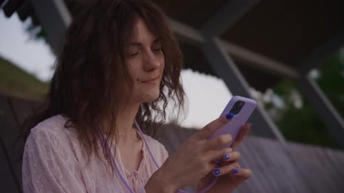 Woman Using Cell Phone in Urban Park