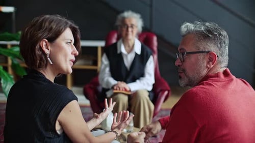 Couple Having Argument and Listening to Therapist on Counseling Session