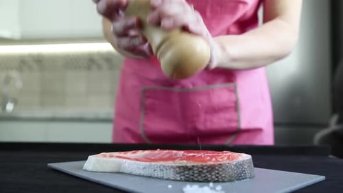 chef prepares a salmon dish in the kitchen. Close-up shots