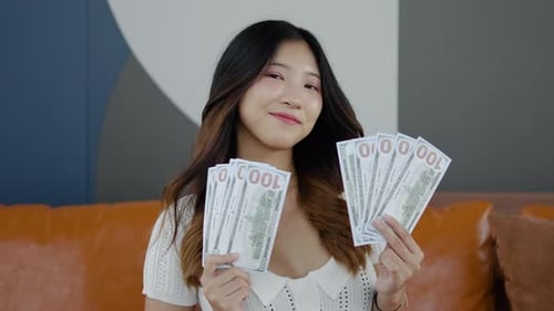 money cash and winning prize, Young happy woman holding fan of money celebration financial success.