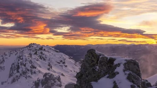 snowy and windy sunset in Navacerrada mountains, Madrid. Lenticular clouds at sunset.