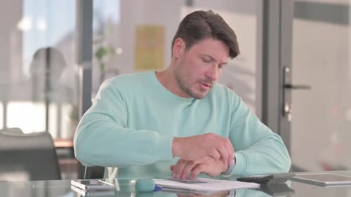 Man Counting Money and Taking Notes in Office