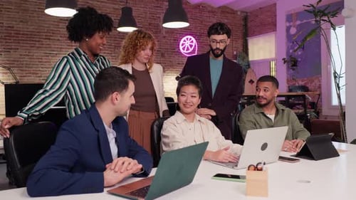 Coworkers Collaborating on Project in Modern Office