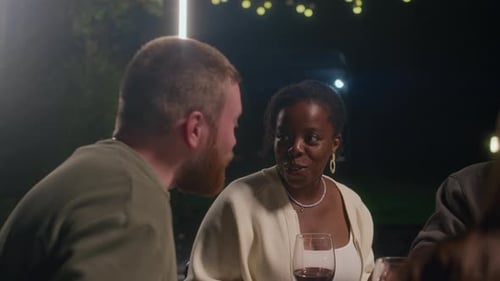 Friends Gather at Night over Wine