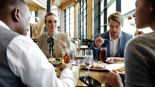 Business People Enjoying Working Lunch In Restaurant