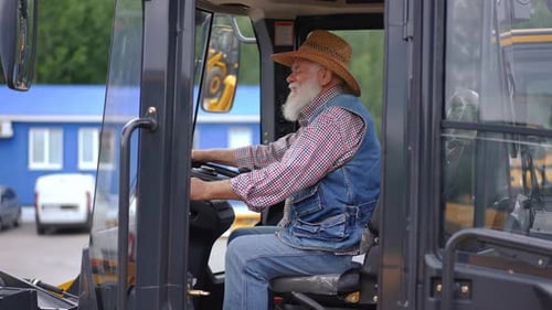 Senior Man in Construction Vehicle Cabin