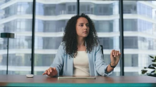Serious businesswoman touching invisible metaverse objects in modern office windows