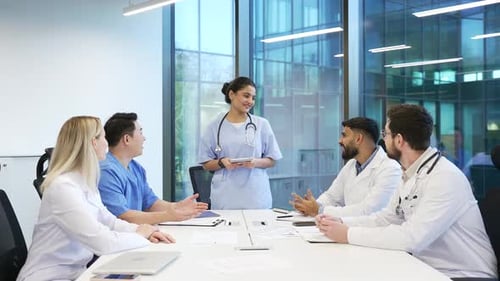 Medical Professionals in Modern Conference Room Applauding Presentation