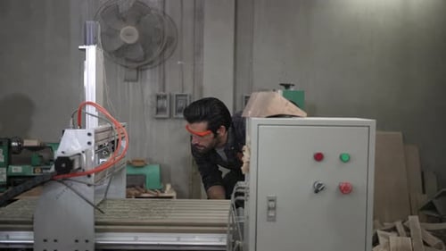 Carpenter is working at workshop.