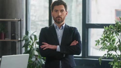 Confident Man in Suit Standing in Modern Office