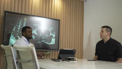 Doctor Discusses Medical Scans with Patient in Office