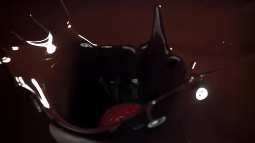 Strawberry Plunging into Dark Chocolate in Slow Motion