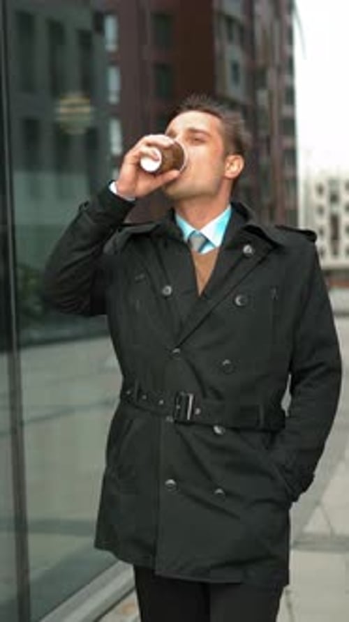 Vertical of Businessman Walking with Coffee Near Business Centre