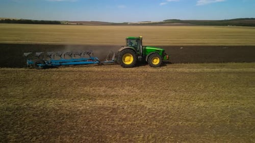 Tractors plowing the field in Ukraine