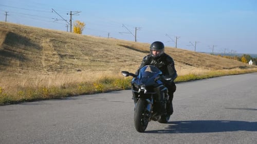 Young Man Riding on Modern Sport Motorbike at Autumn Highway Motorcyclist Racing His Motorcycle on