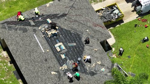 Roofing Crew Repairing House Roof Aerial View