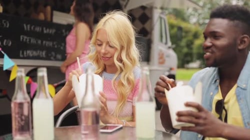 Friends Enjoying Takeout Food at a Food Truck