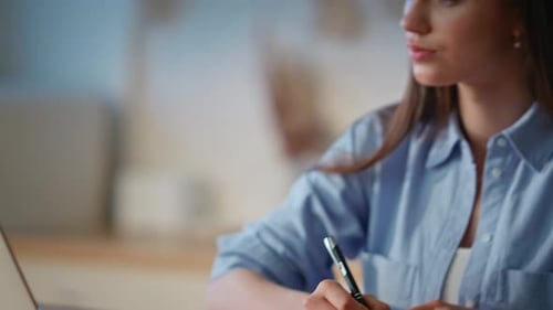 Woman Hand Writing Notes Working at Home Kitchen Closeup Lady Looking Laptop