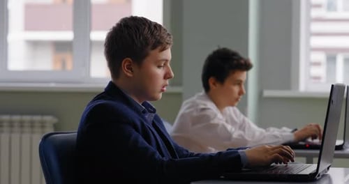 Teen Students Use Laptops in Classroom Setting