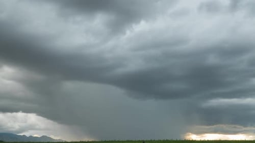 Thunderstorm Over Rural Landscape with Lightning and Rain
