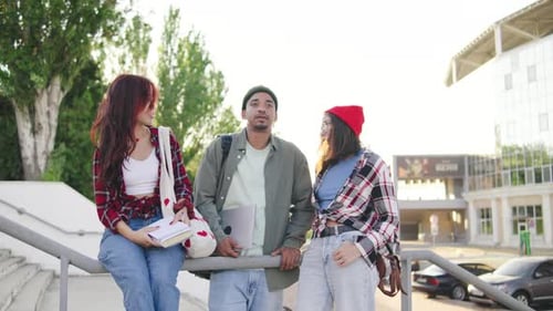 Group of Multiracial Students Friends Enjoying a Sunny Day While Walking Outside a Campus Building