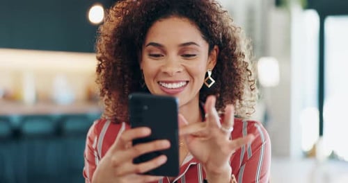 Smiling Woman Using Smartphone Indoors