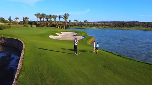 Man Teaching Golf to Children on Tropical Course