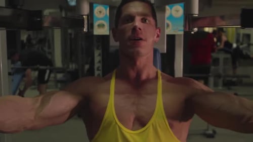 The sportsman is engaged in the gym strength training at the gym