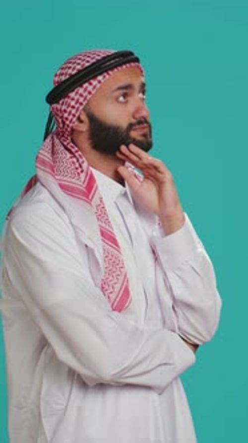 Man in Traditional Robe Deep in Thought