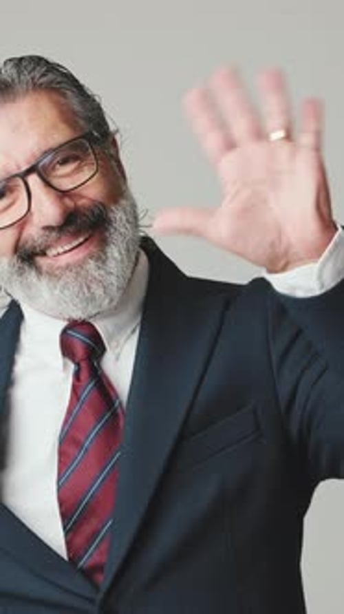 Smiling Man with Beard Waves in Business Suit