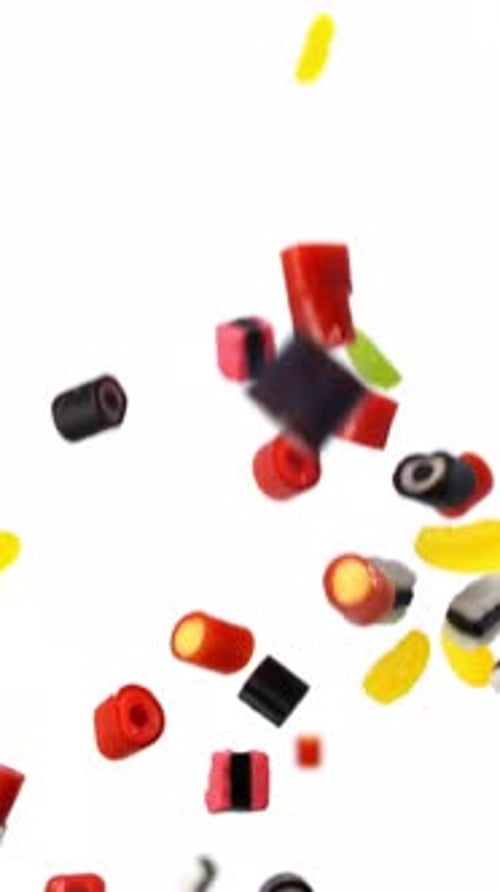 Colorful Candies Falling in a Close-up Vertical Shot
