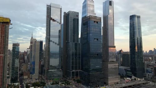Aerial drone view towards tall skyscrapers in Hudson Yards, sunset in New York, USA