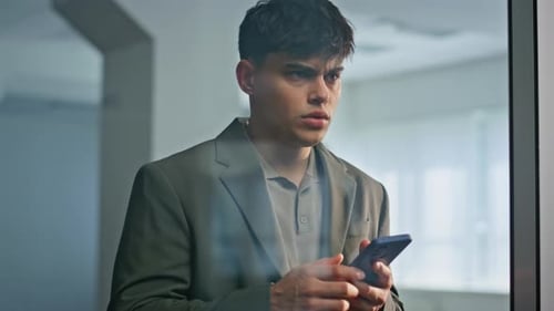 Frustrated Businessman Checking Smartphone at Office Closeup Man Touching Head