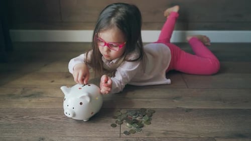 Child Collects Money in Piggy Bank Girl Learns to Invest Money Saving Piggy Bank and Little Girl