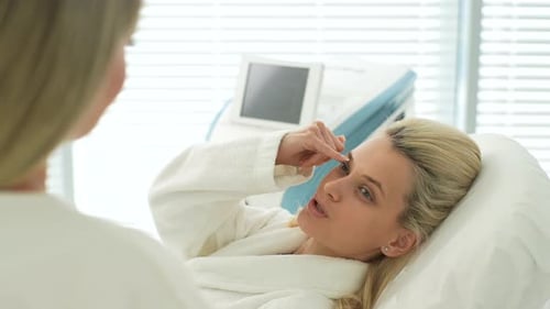Closeup Back View to Young Blonde Woman Lying at Cosmetology Visit in Comfortable Couch Beauty