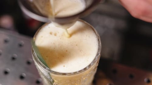 Liquid Being Strained into a Glass