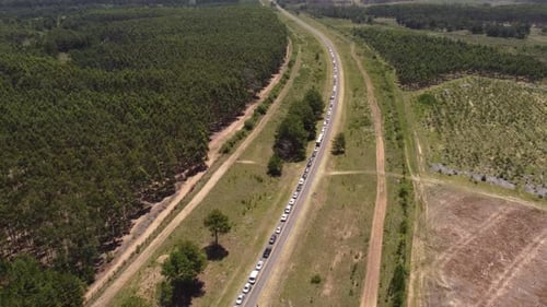 Drone overhead shot of traffic jam on rural road between Argentinian and Uruguay border