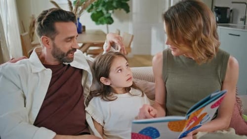 Caring Parents Communicating Daughter at Couch Closeup Family Reading Book