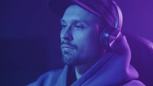 computer player with headphones, hand gesture no