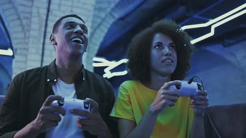 Smiling Friends Playing Video Games in Blue Room