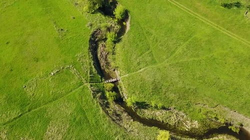 Aerial Footage of Camera Flying Over the Picturesque Valley Green Fields and Hills Rocky Cliffs and