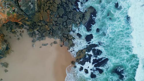 Stormy Ocean Waves Splashing Foaming on Rocky Coast. Aerial View Stunning Sea