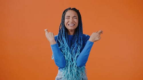 Expressive Woman Showing Emotions on Orange Background