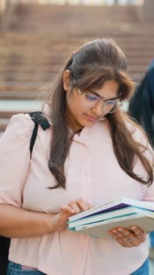 Young Indian Female Student Reading Books at University Campus