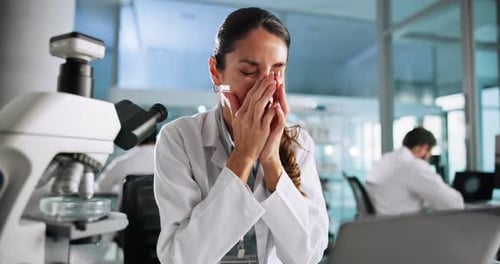 Tired Woman in Lab Rubbing Her Eyes