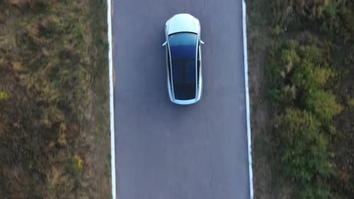 Aerial Shot of Electrical Car Driving on Country Road New SUV Vehicle Moving Along Route Ecology