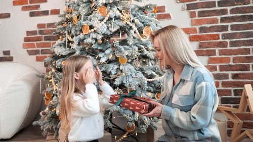 Loving Mother and Daughter Exchanging Christmas Gifts